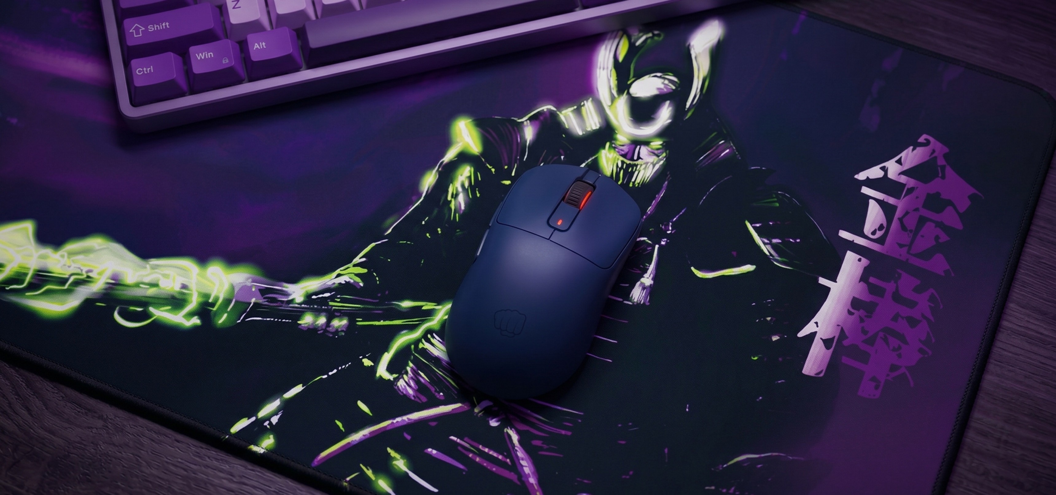 A computer mouse on a colorful mouse pad featuring a character with glowing green effects.