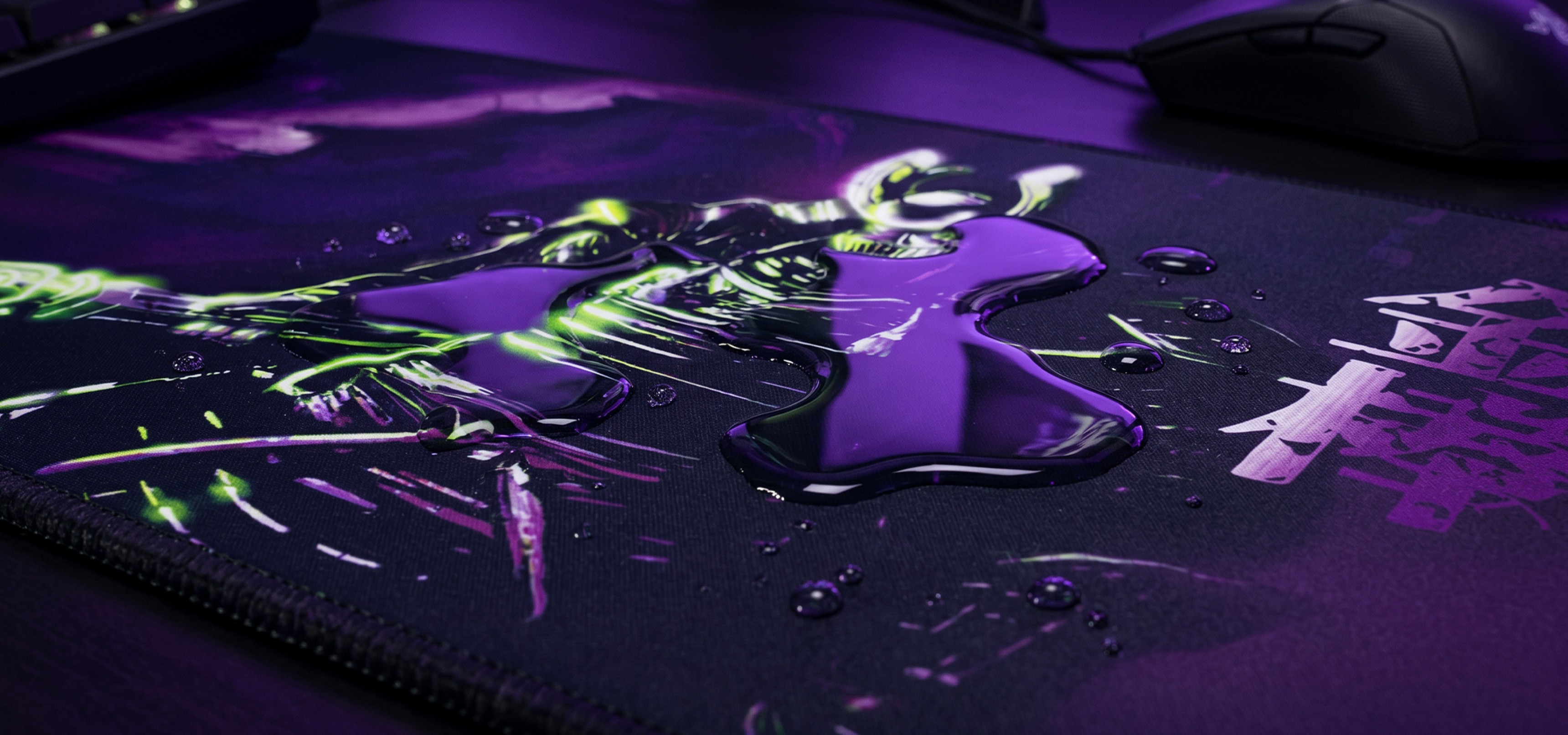 Gaming mousepad with colorful design and liquid droplets on its surface.