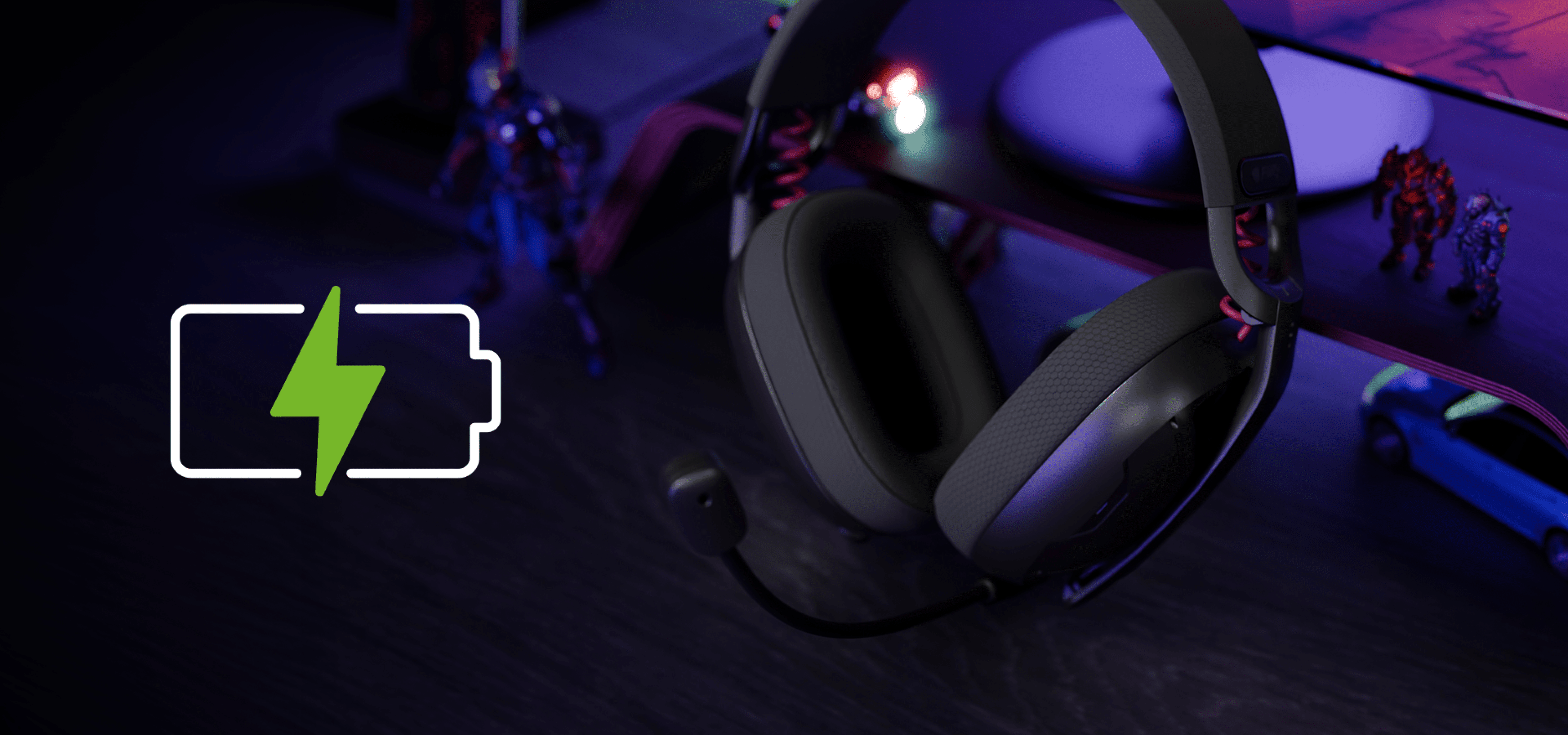 Headset displayed on a dark surface with a charging symbol and colorful figures nearby.