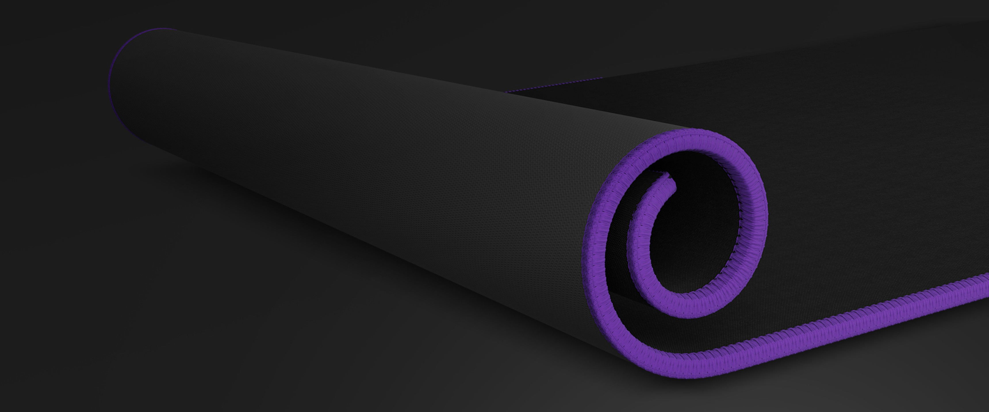 Black mouse pad with a textured surface, featuring a purple stitched edge, rolled slightly from one corner