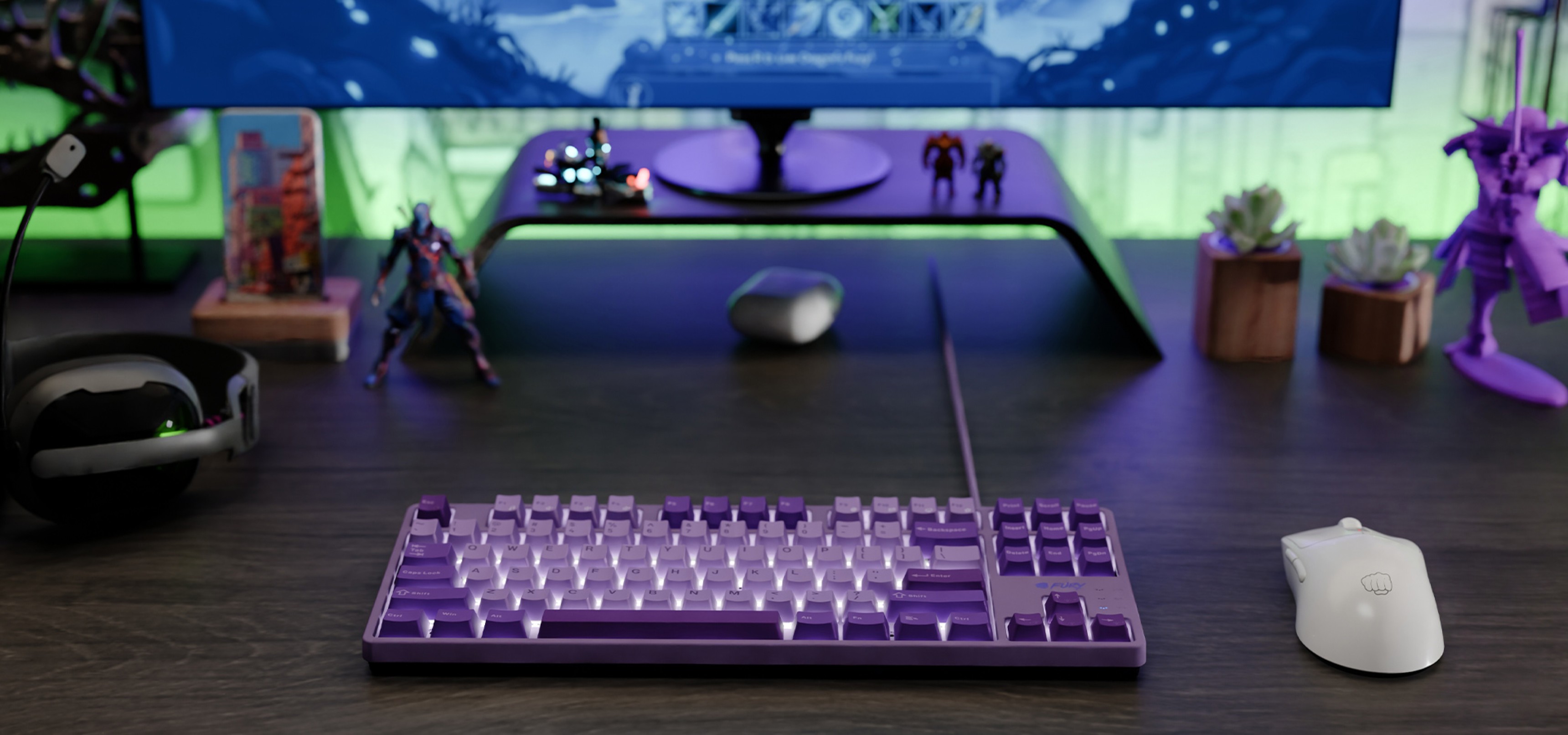 A purple keyboard with illuminated keys next to a white mouse on a dark desk.