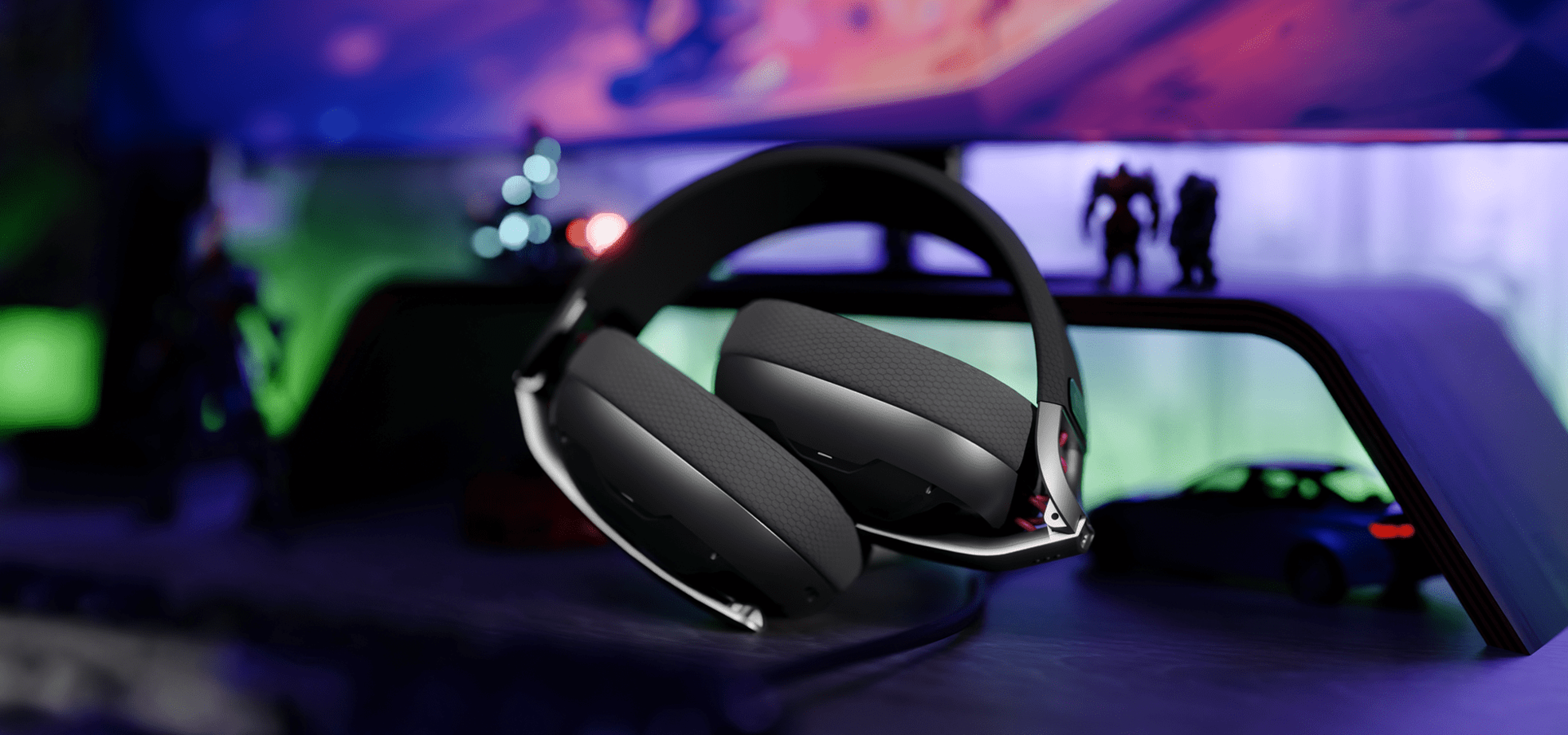 Headset with cushioned ear pads placed on a shelf in a colorful gaming setup.