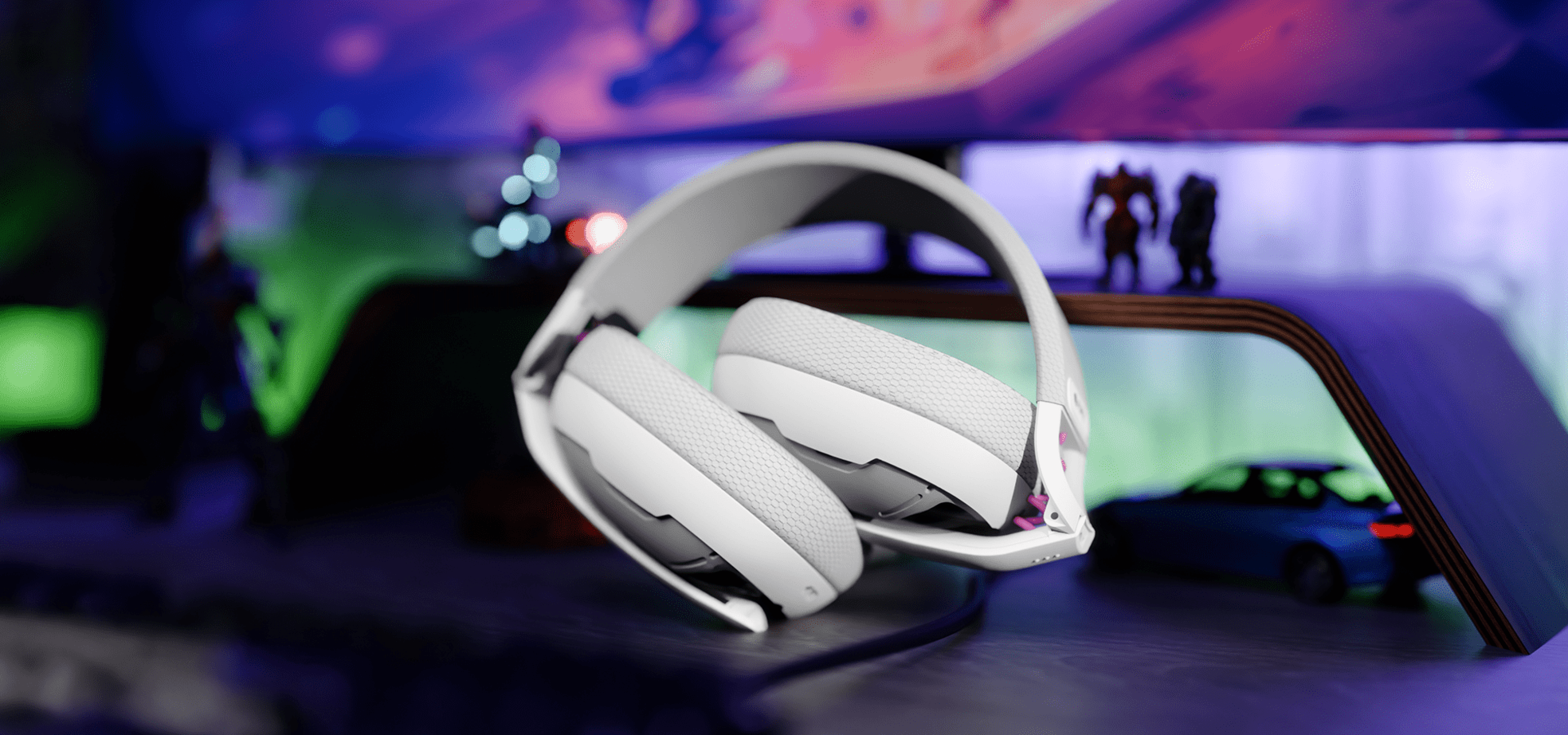 Headphones in white color placed on a blurred surface with a colorful background.