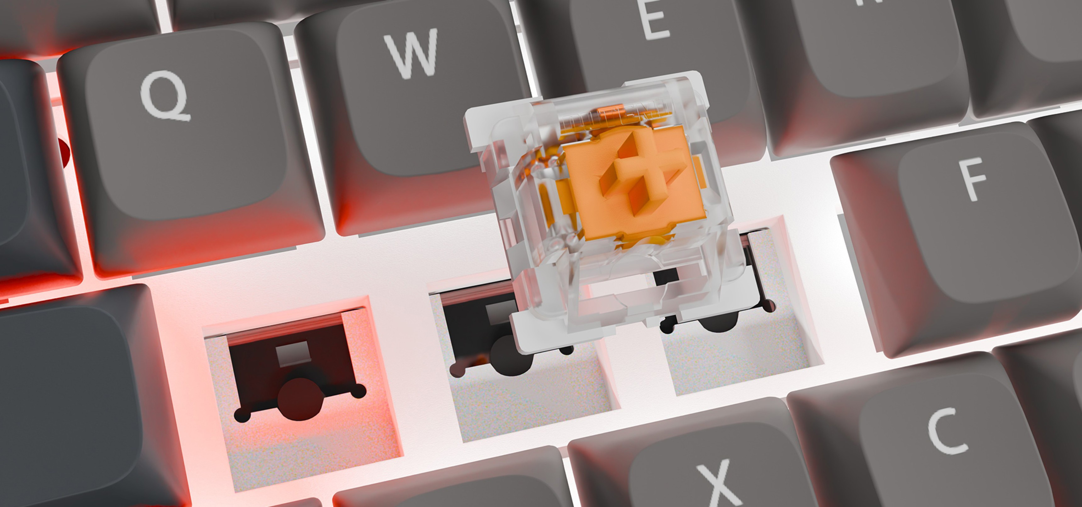 Close-up of a keyboard key switch above a keycap removed from the keyboard surface.